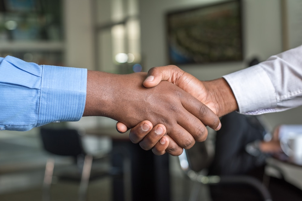 Business professionals shaking hands across a desk